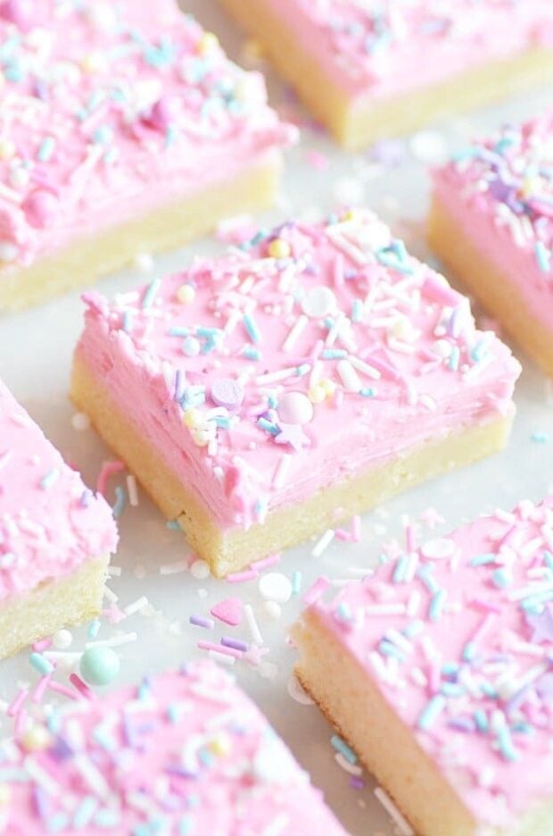 Super soft sugar cookies piled with vanilla buttercream frosting and lots of sprinkles! Tastes just like a Lofthouse Sugar cookie, and so easy to bake since they're in bar form.