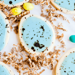 Soft cut-out sugar cookies that hold their shape, simple icing, and a cocoa splatter that makes these Easter Egg Sugar Cookies look speckled!